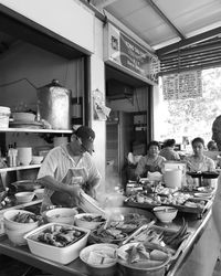 Chefs preparing food in commercial kitchen at restaurant