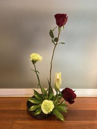 Close-up of roses in vase on table