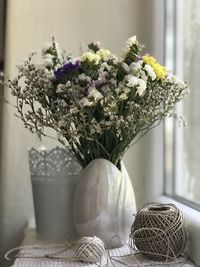 Close-up of flower vase on window sill