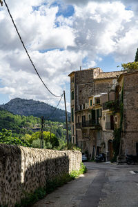 Street amidst buildings against sky