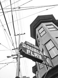 Low angle view of telephone pole against sky