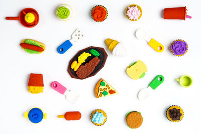 High angle view of multi colored candies against white background