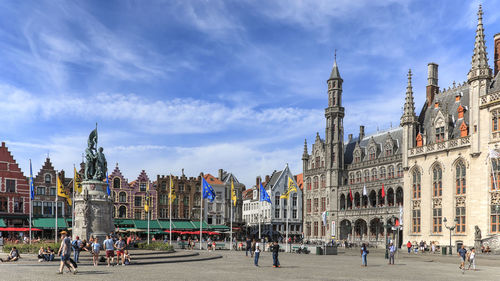 Panoramic view of people in city against sky