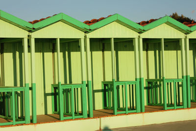 Multi colored houses in row against buildings