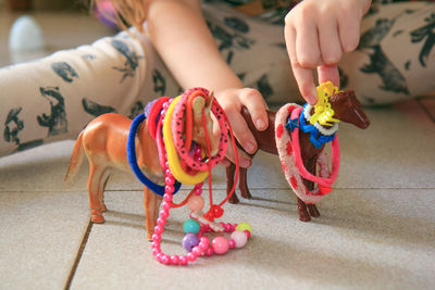 Midsection of girl playing with toy toys