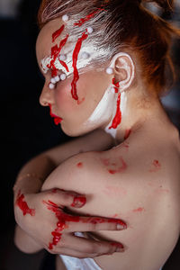 Close-up of young woman with creat makeup 