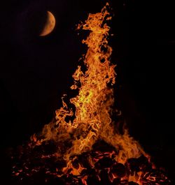 Bonfire against clear sky at night