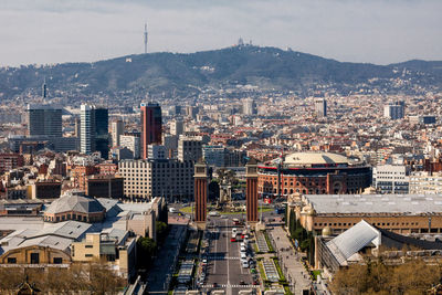 High angle view of city buildings against sky