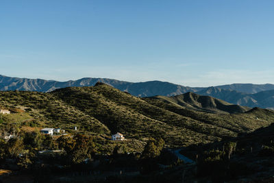 Scenic view of mountains against blue sky