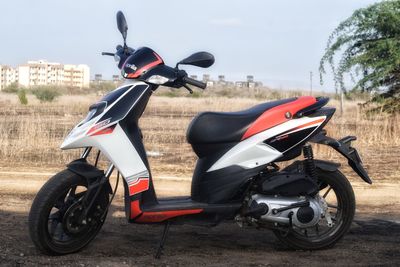Close-up of motorcycle on road against sky