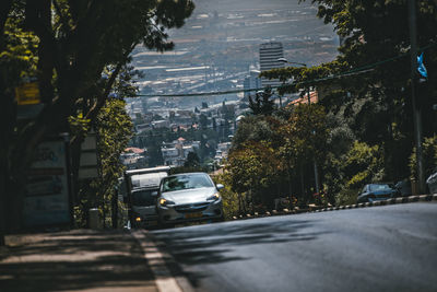 Cars on street by buildings in city