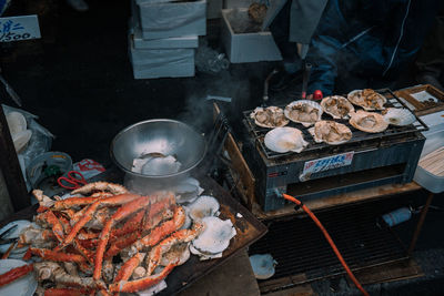 Midsection of man preparing food on barbecue grill