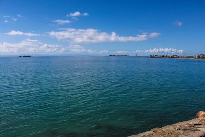 Scenic view of sea against blue sky