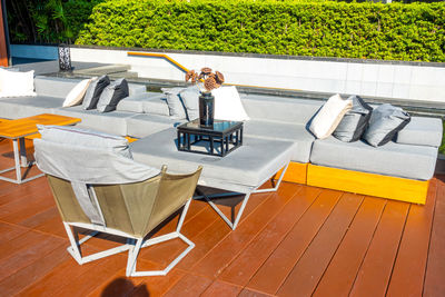 High angle view of chairs and tables at swimming pool