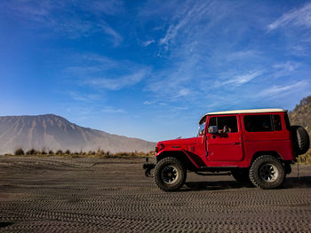 Vintage car on land against sky