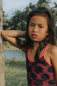 Portrait of teenage girl standing on land