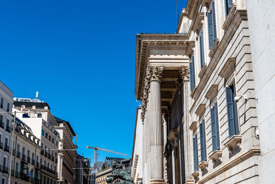 Low angle view of buildings against blue sky