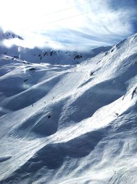 Scenic view of snow covered mountains against sky