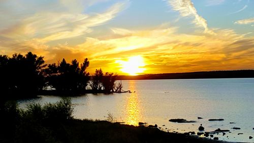 Scenic view of sea against orange sky