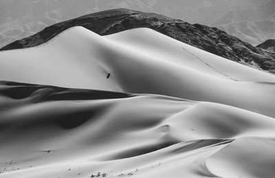 High angle view of sand dune and mountains 