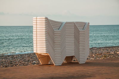 Lifeguard hut on beach against sky