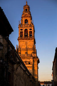 Low angle view of clock tower in city against sky