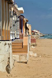 Buildings at beach against sky