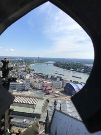 High angle view of buildings by sea against sky