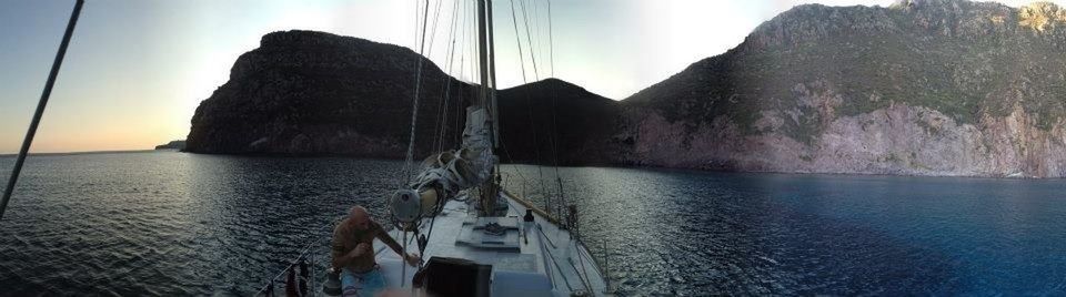 water, sea, nautical vessel, mountain, sky, boat, transportation, mode of transport, scenics, tranquil scene, tranquility, beauty in nature, nature, mast, rock formation, sailboat, mountain range, waterfront, idyllic, rock - object