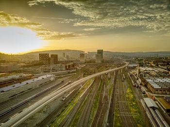 Aerial view of cityscape against cloudy sky