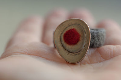 Cropped hand on person holding old ring