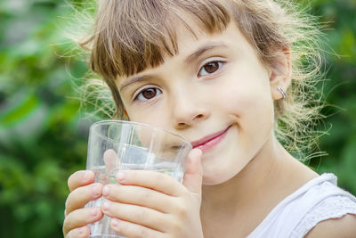 Close-up of young woman holding drink