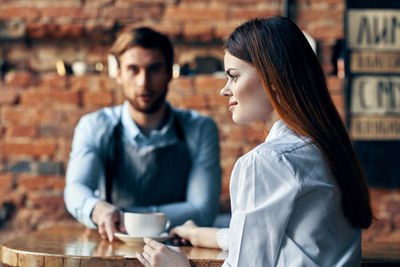 Young woman with coffee in cafe