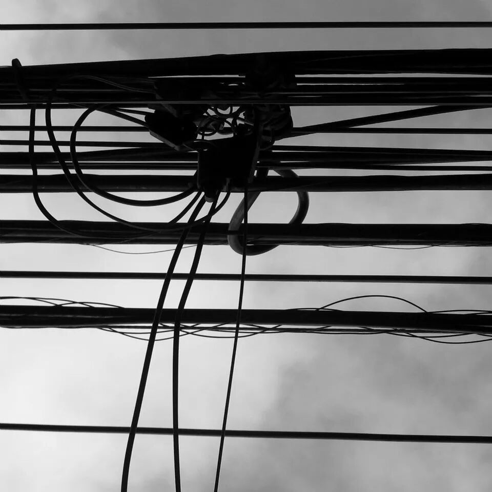 low angle view, built structure, sky, connection, architecture, metal, cable, day, power line, silhouette, railing, outdoors, no people, electricity, bridge - man made structure, electricity pylon, clear sky, cloud, metallic, part of