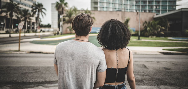 Rear view of couple standing in city