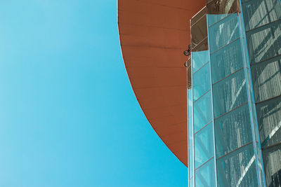 Low angle view of modern building against clear blue sky