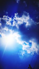 Low angle view of bright sun in sky