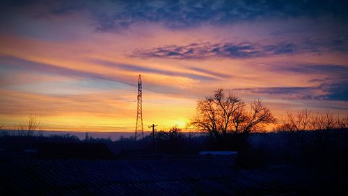 Silhouette trees against sky during sunset
