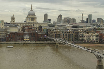 View of cityscape against cloudy sky