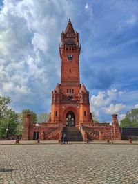 Low angle view of clock tower against sky
