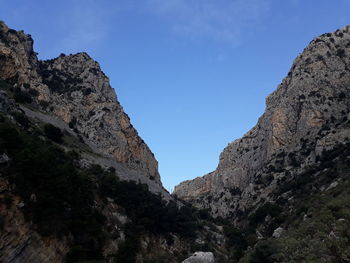 Low angle view of rock formation against sky