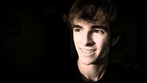 Smiling man looking away at home