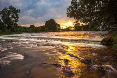 Scenic view of river against sky during sunset