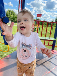 Portrait of cute girl playing with camera