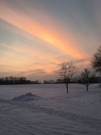 Scenic view of snow field against sky during sunset