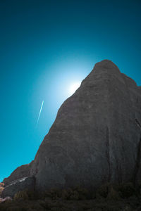 Low angle view of mountain against clear blue sky