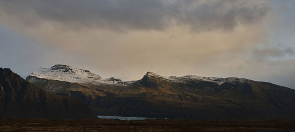 Scenic view of snowcapped mountains against sky