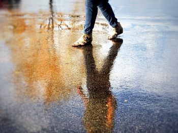 Low section of man in puddle on street