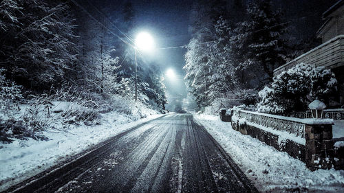 Snow covered road at night