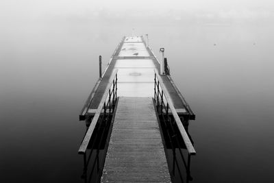 High angle view of pier at river during foggy weather